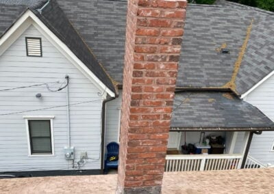 deteriorated leaning chimney with bricks and red mortar