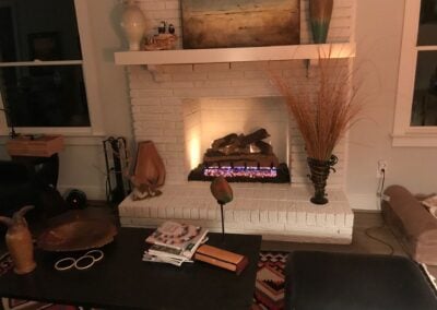 white brick open fireplace with gas logs
