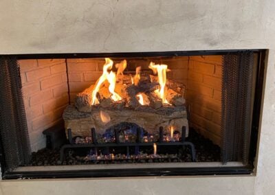 white marble fireplace with gas logs
