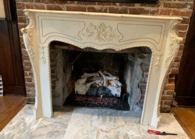 gas logs in ornate fireplace