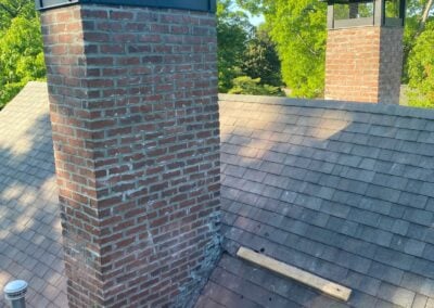 two new chimney caps on brick chimneys
