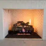 A cozy fireplace with stacked logs, creating a warm and inviting atmosphere